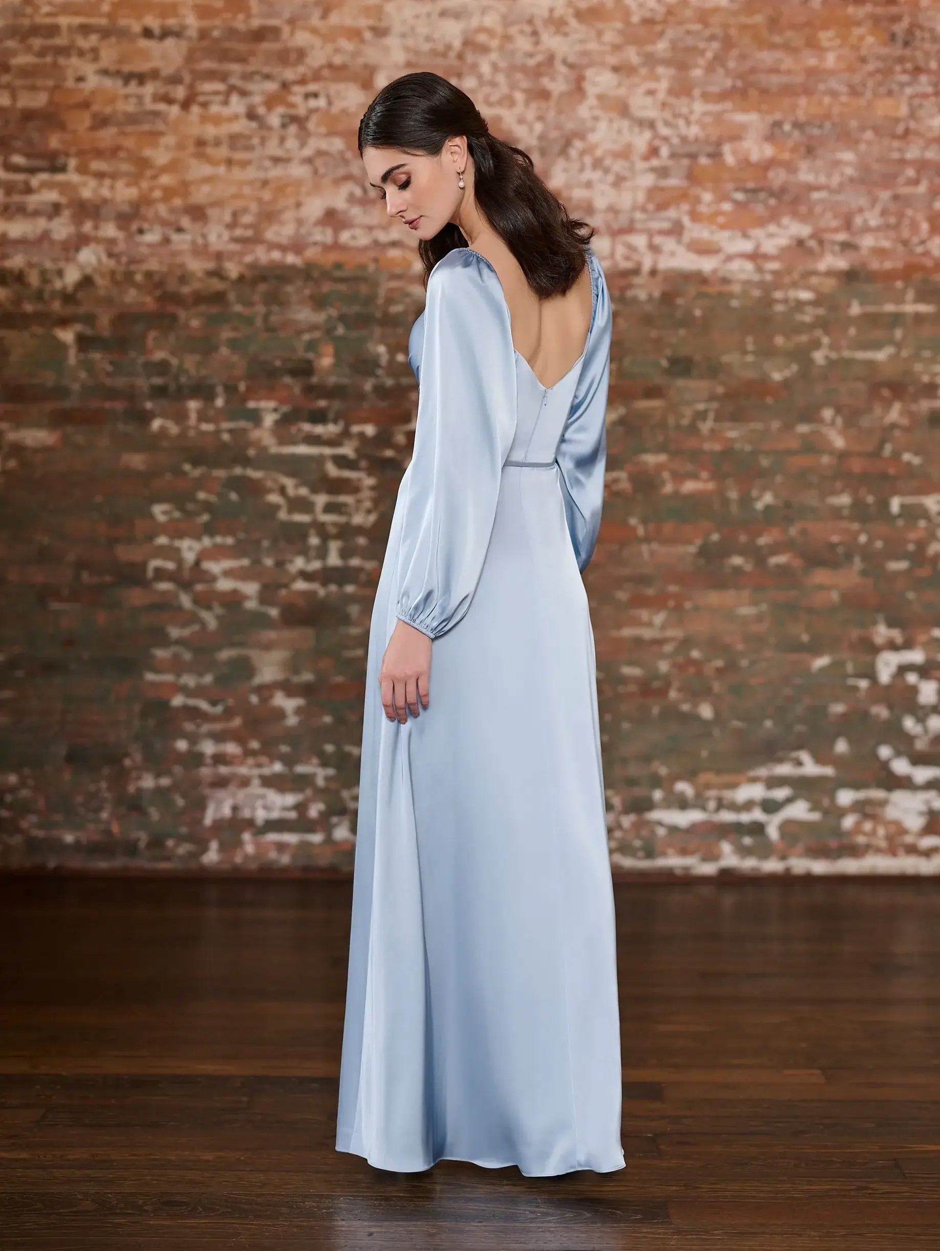 Model is wearing an a-line bridesmaid dress with balloon sleeves 