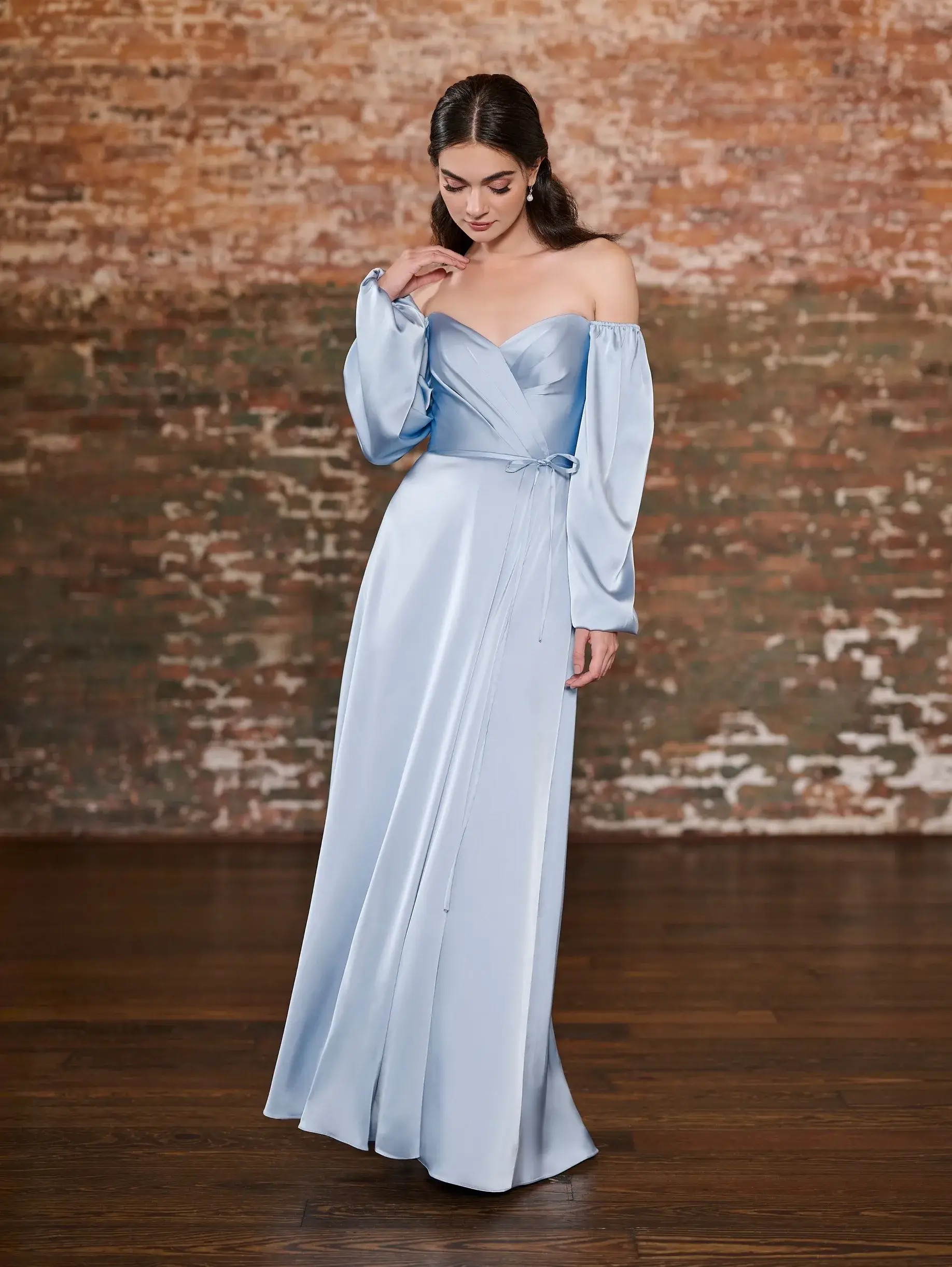 Model is wearing an a-line bridesmaid dress with balloon sleeves 