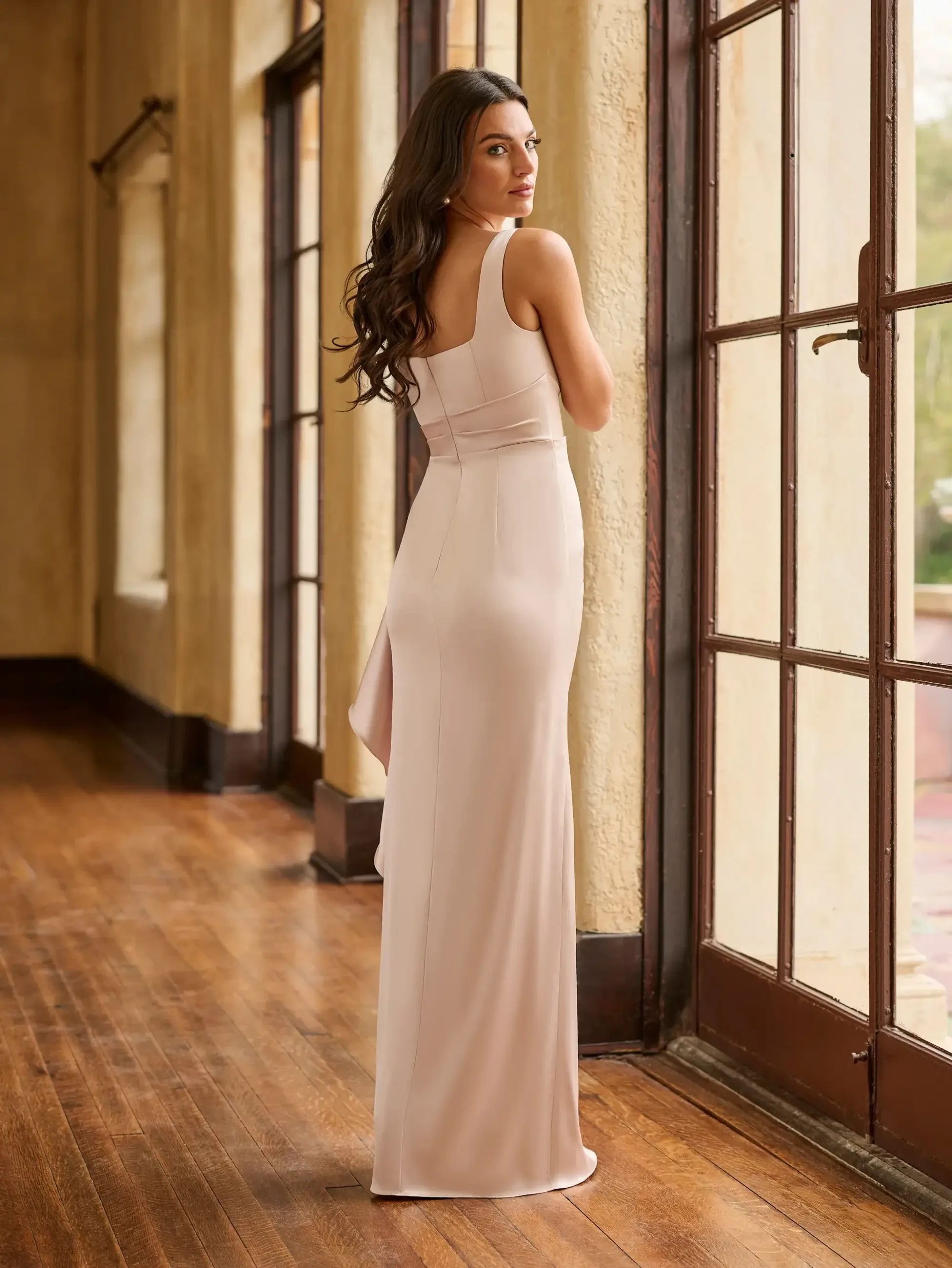 Model is wearing a Christina Wu Celebration 22270, a light pink square neck tank stretch matte charmeuse sheath with cascading skirt ruffles.