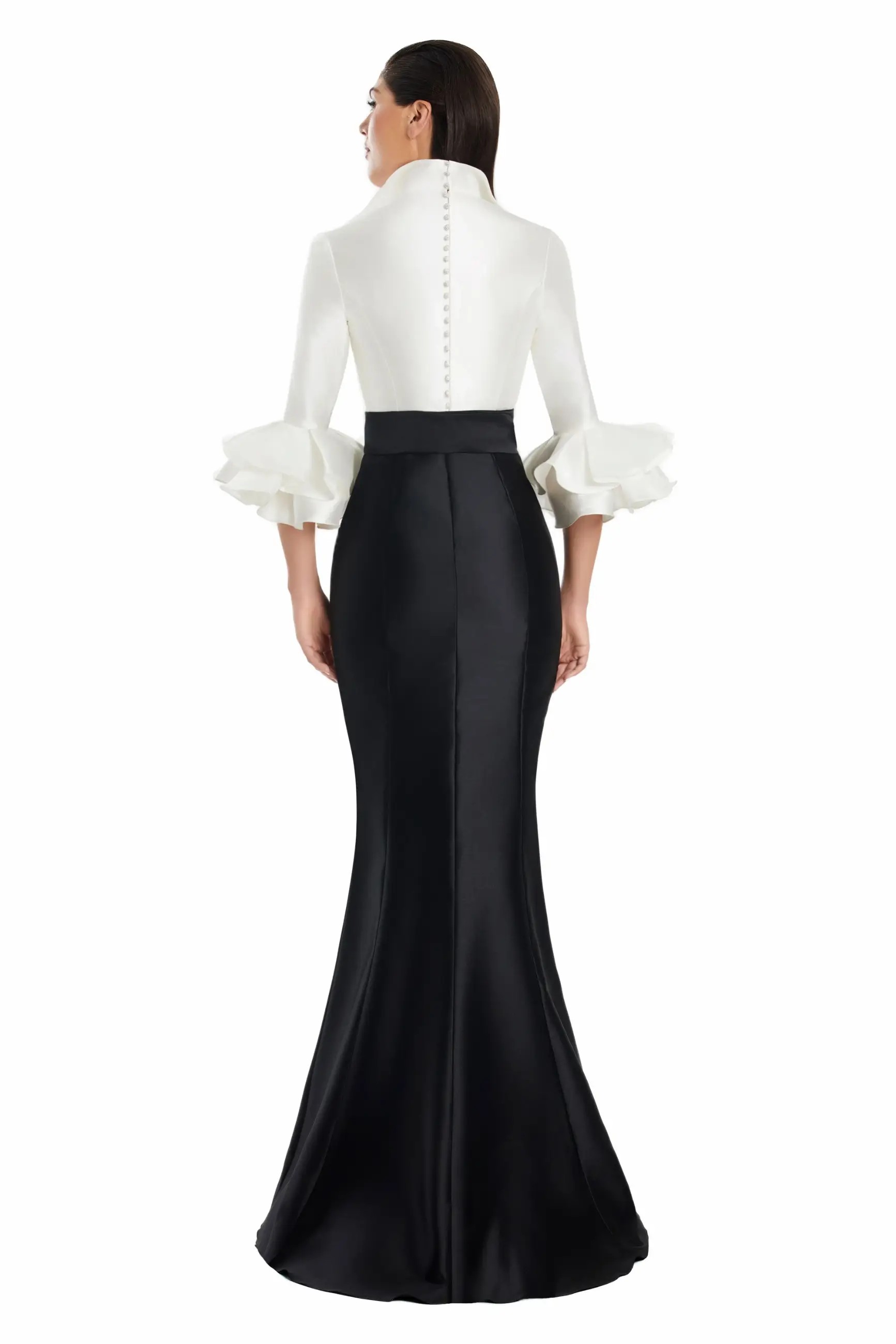 Model is wearing a satin mermaid gown with three quarter ruffled sleeves