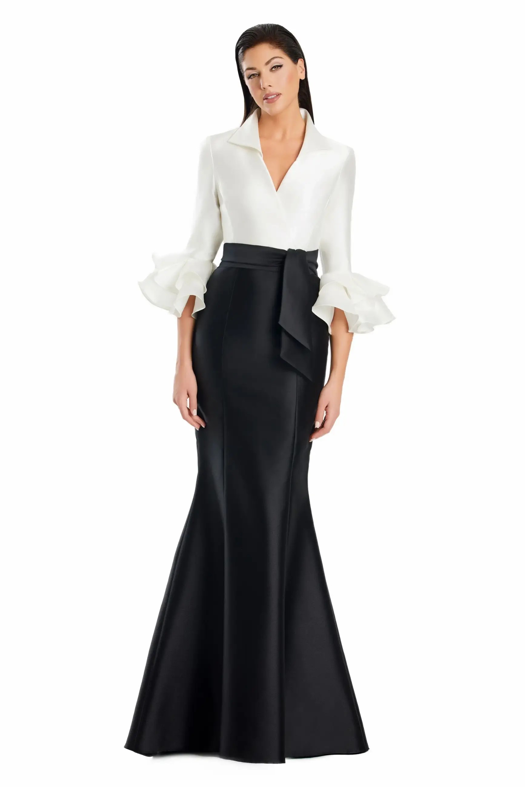 Model is wearing a satin mermaid gown with three quarter ruffled sleeves