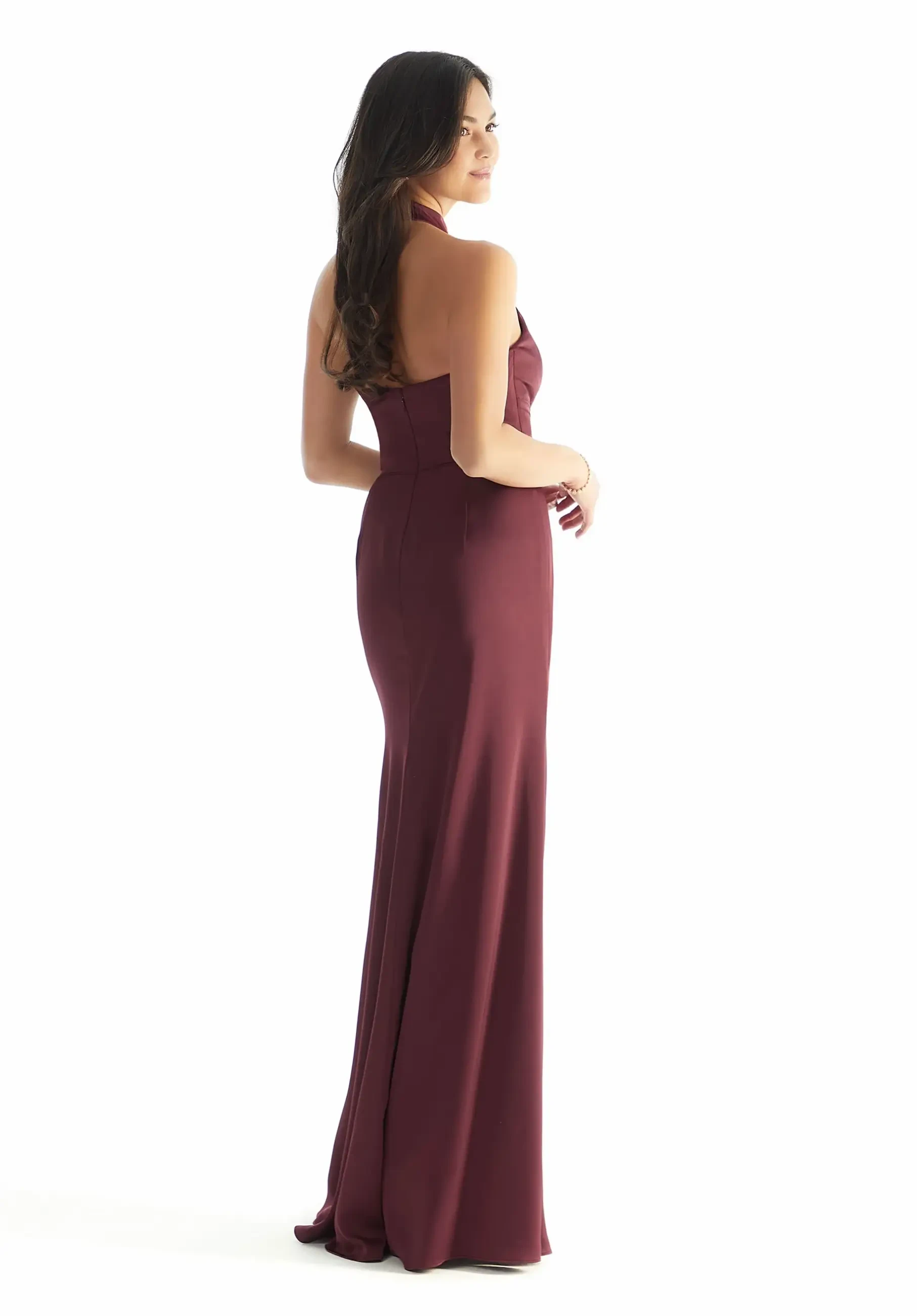Model is wearing a Morilee 31224, a wine-colored collar-style halter satin sheath with a curve-hugging fit and front skirt slit.