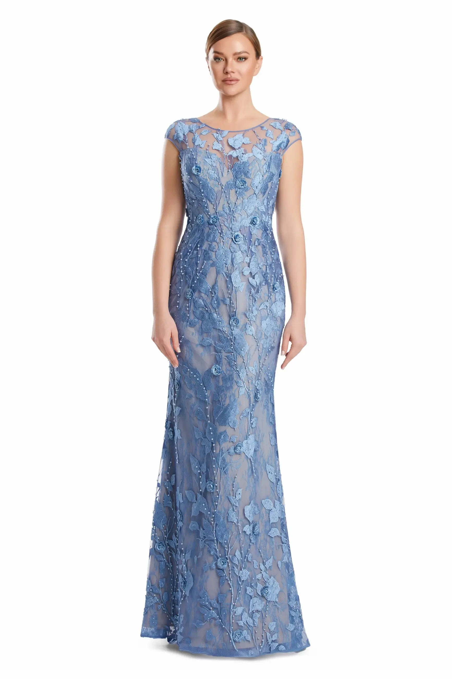 A woman wearing a light blue floral-embroidered evening gown with cap sleeves, standing against a white background.