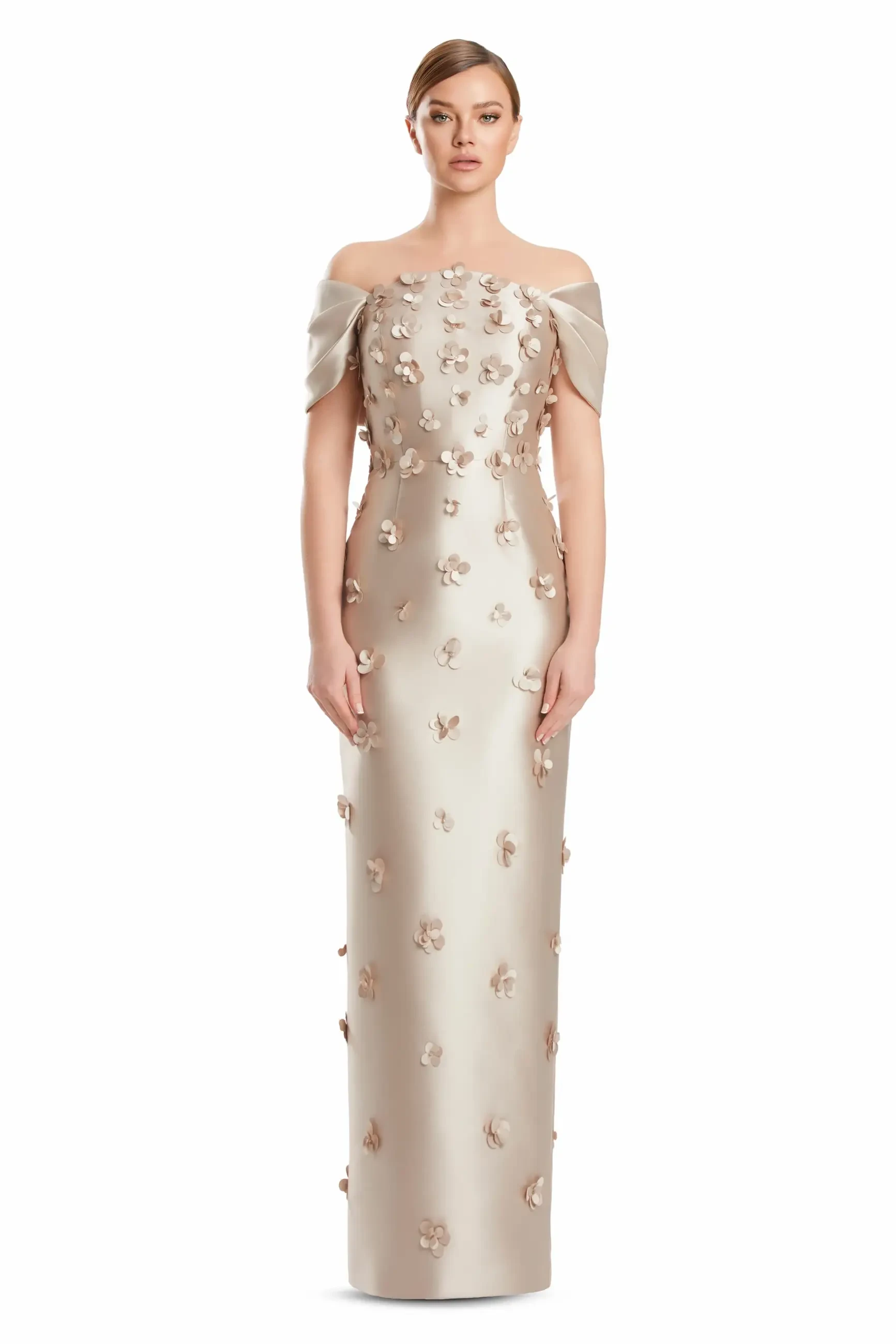 A model wearing an off-shoulder, form-fitting gown with floral embellishments throughout.