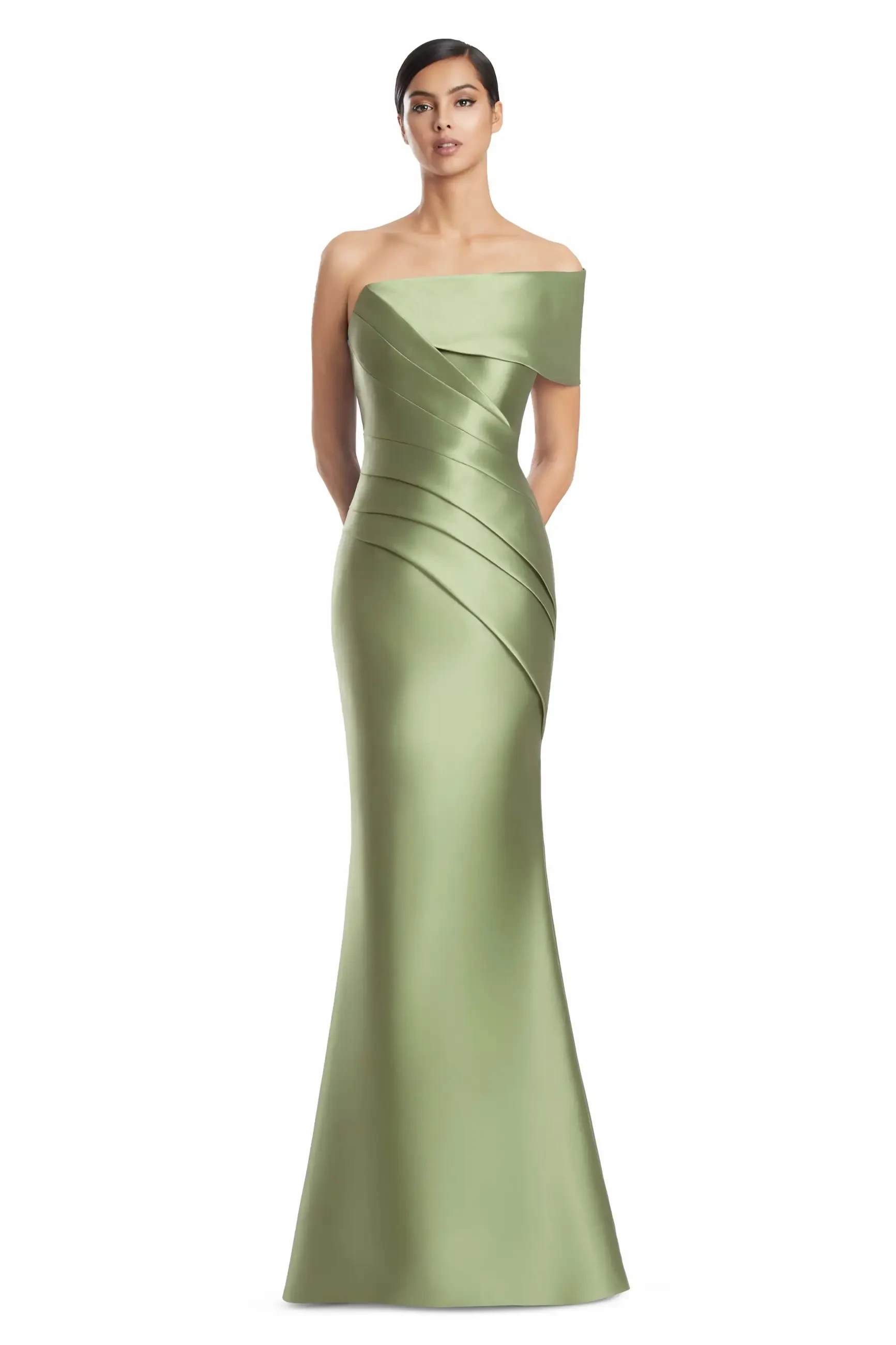 A woman wearing an elegant, off-shoulder, fitted gown in a light green color with draped detailing.