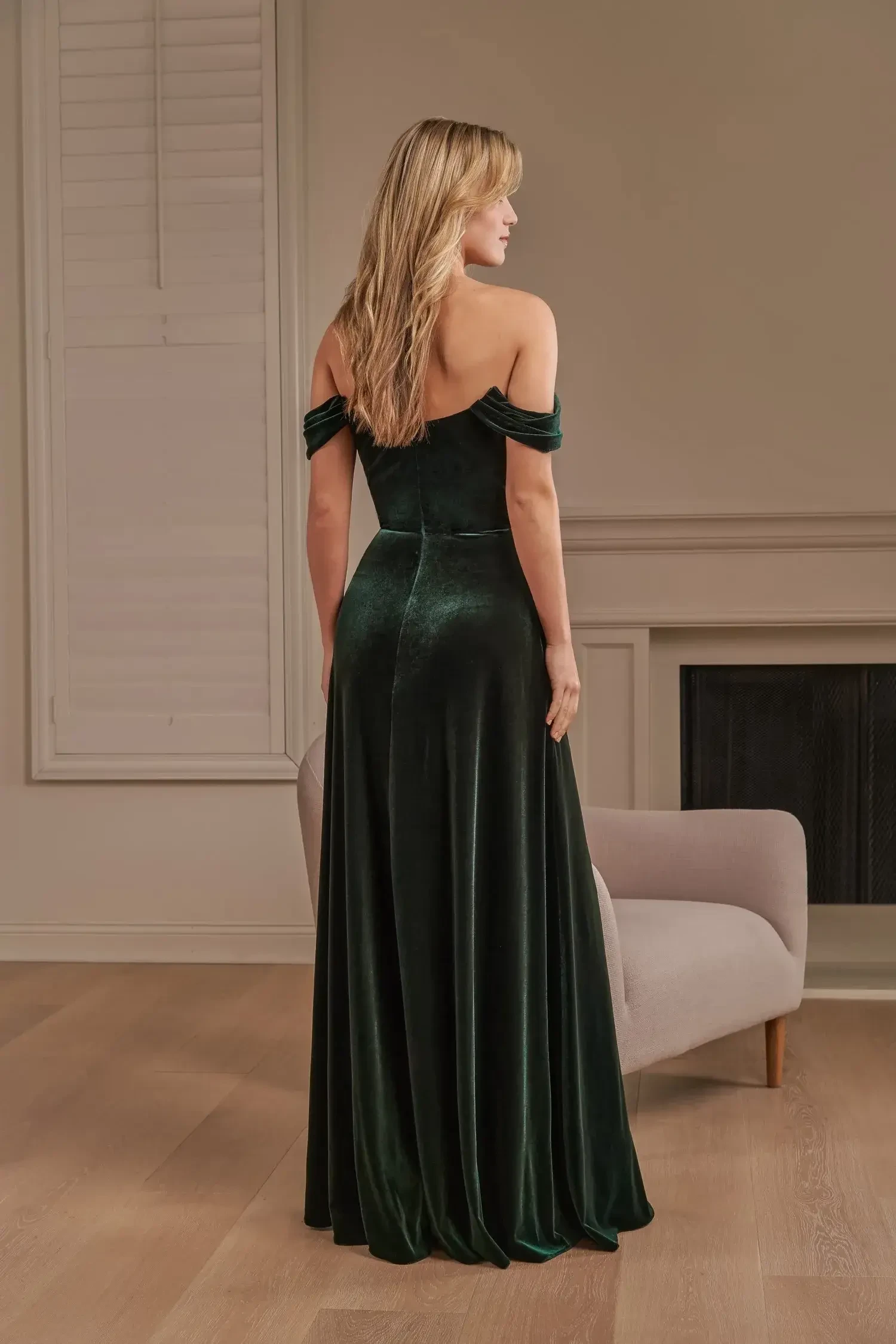 Model is wearing a stretch velvet dark green bridesmaid dress