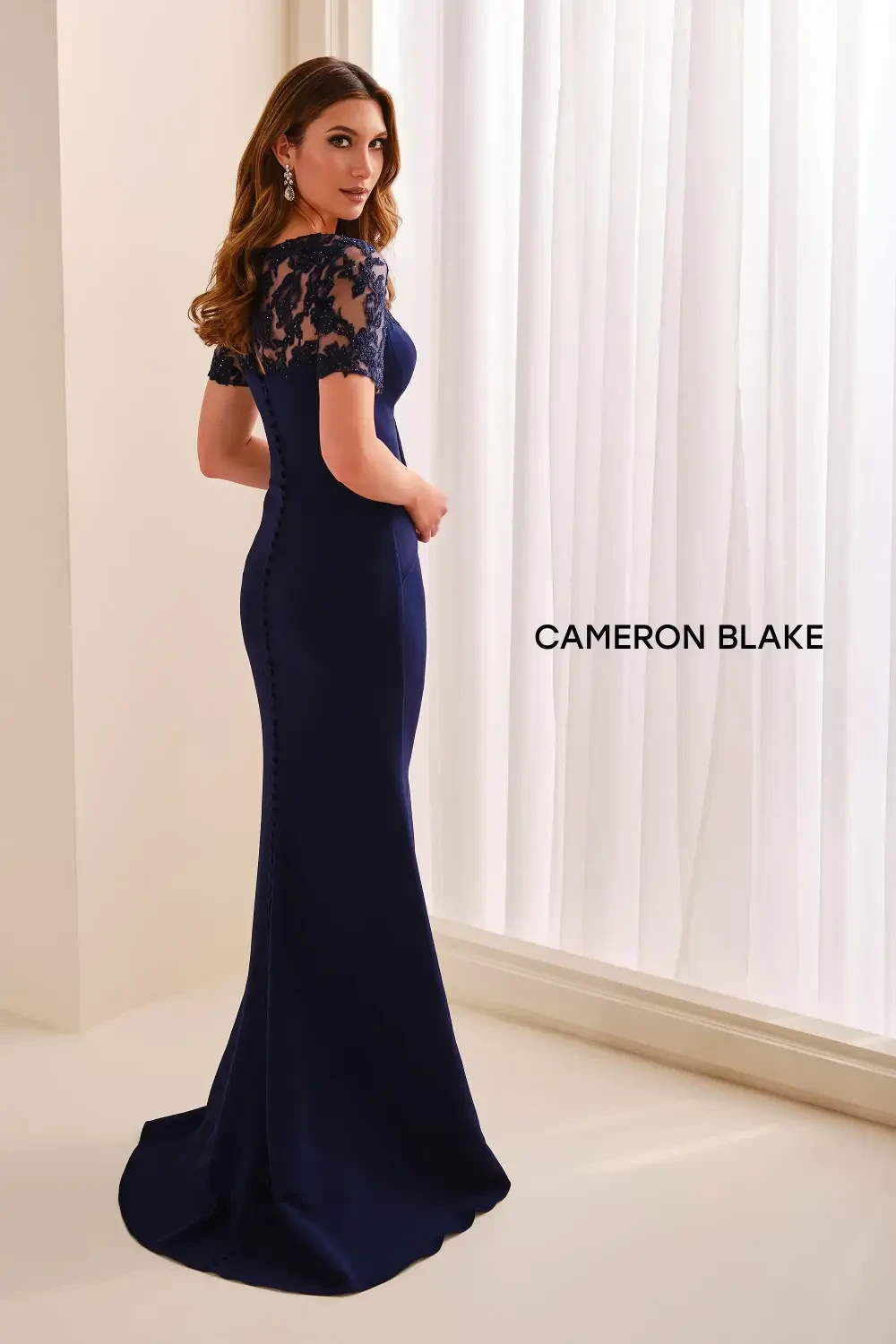 model is wearing a fitted blue evening gown