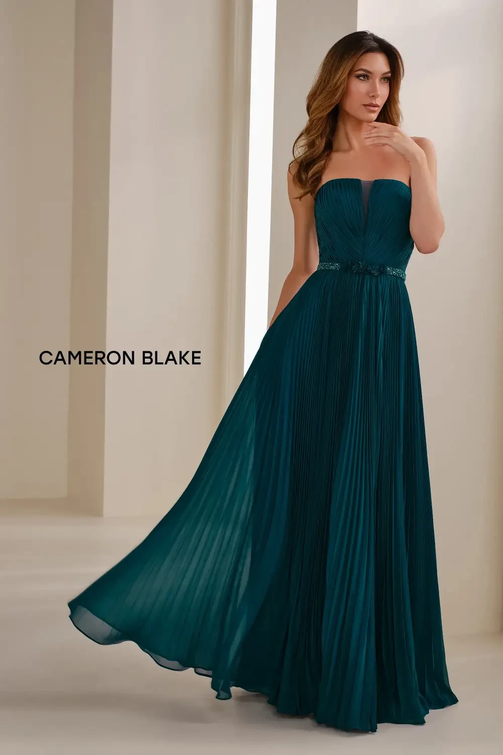 model is wearing a strapless green mother of the bride gown