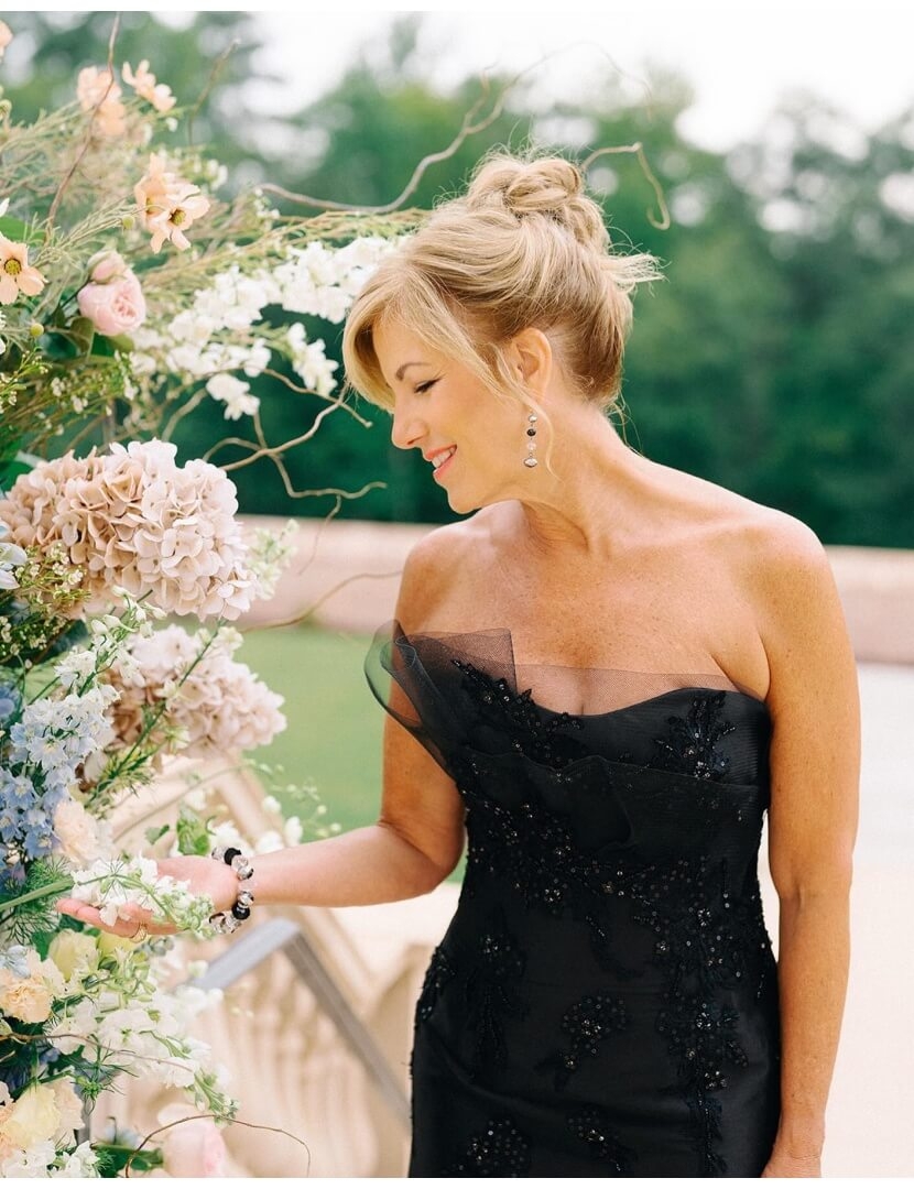 Model wearing a white black dress near the flowers