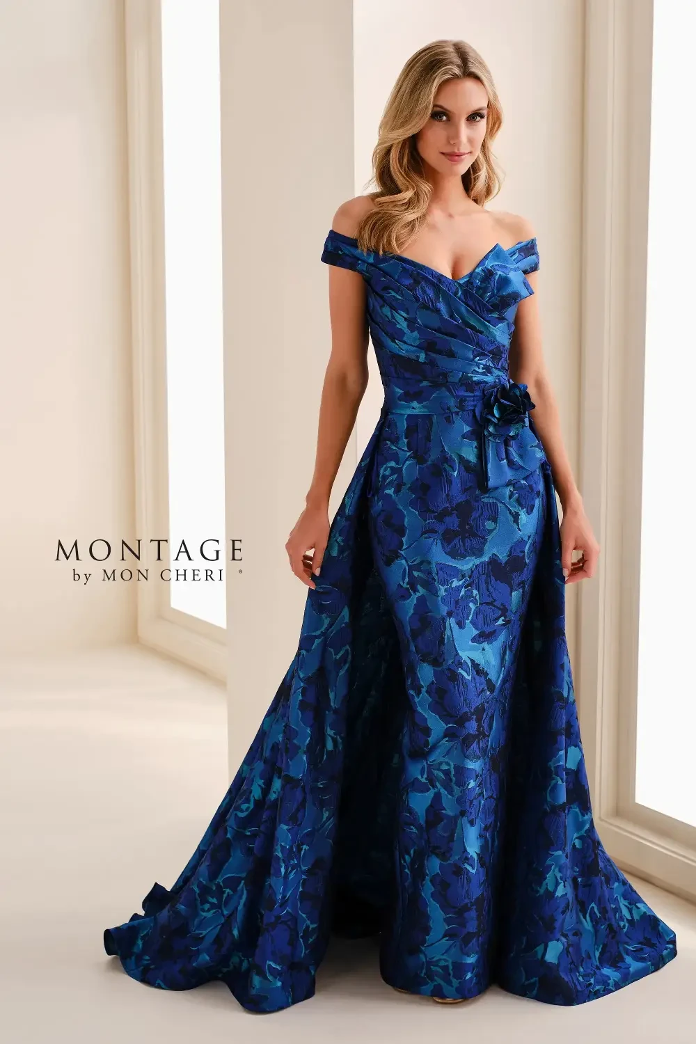 model is wearing an off the shoulder blue mothers gown