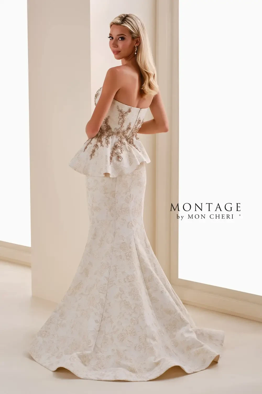 model is wearing a strapless gold peplum mother of the bride gown