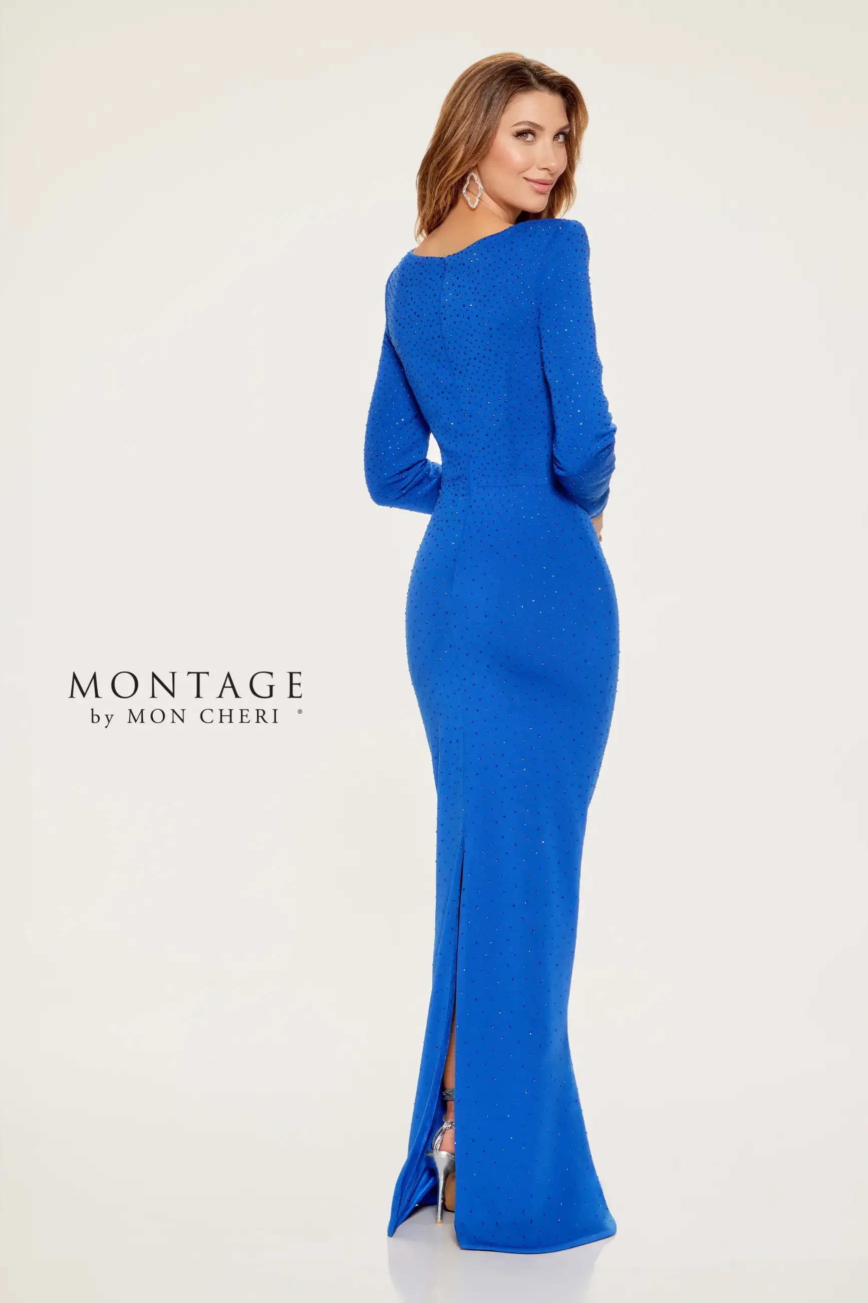 Model is wearing a long sleeve sheath gown with a square neckline